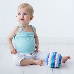 A colorful crocheted ball rattle in shades of blue, pink, orange, and green. The rattle features a round, textured design with a soft, plush texture.