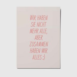 A postcard with the text "Wir haben sie nicht mehr alle, aber zusammen haben wir alles :)" in red lettering on a light background. The postcard appears to be a greeting card or note with a simple, minimalist design.
