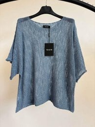 "Oversized denim blue short sleeve t-shirt, relaxed fit, textured fabric, available in multiple colors"