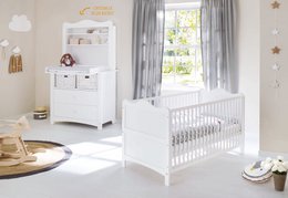 White crib with changing unit and wide shelf unit, suitable for a nursery.