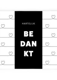 Chocolate bar with "BEDANKT" text in white on a black background. Two heart-shaped chocolates with a red and brown color scheme.