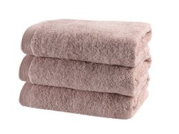 Soft, plush bath towels in a variety of muted pink and neutral tones. Ideal for a relaxing spa-like experience.