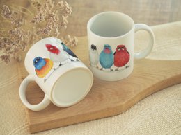  Ceramic mug featuring colorful South American bird designs, suitable for use as a decorative or functional item.