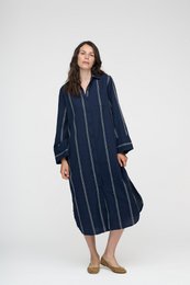 Dark navy and white vertical striped shirt dress, long sleeves, casual daylight style, midi length.