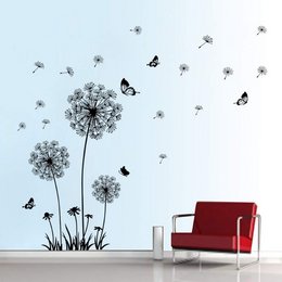 Dandelion and butterfly wall sticker featuring black silhouettes of dandelion flowers and butterflies on a light blue background. The sticker can be used to decorate walls in homes, offices, or other indoor spaces.