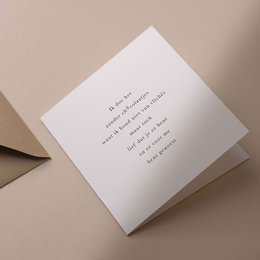 A box of assorted chocolates in a thank you card design. The chocolates are arranged in a square pattern, with a simple text message printed on the card.