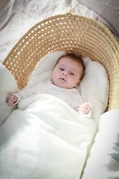 Ivory-colored baby sleeping bag/wrap, swaddle for sleeping. Soft, cozy material. Suitable for newborns and infants.