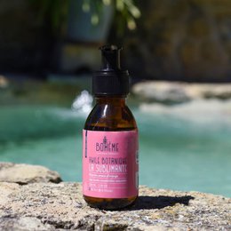 Organic body oil with orange peel scent, containing vitamins and antioxidants for nourished skin.