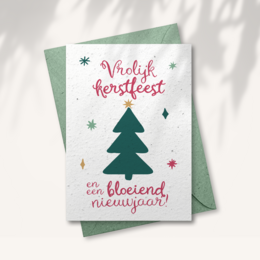 Seed paper Christmas card with a festive tree design and text wishing a "Vrolijk Kerstfeest" (Merry Christmas) and "Een bloeiend nieuwjaar" (A blooming new year).