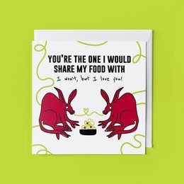 Whimsical greeting card featuring two red foxes sharing a bowl of food, with the text "You're the one I would share my food with". The card is designed for a love or friendship theme.