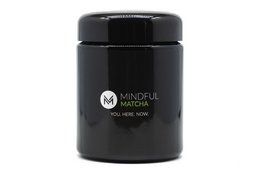 Organic matcha green tea powder in a black container. Vibrant green color. Suitable for tea, lattes, and baking.