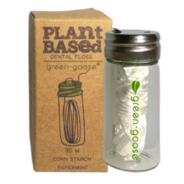 Mint-flavored, plant-based dental floss in a recyclable container.