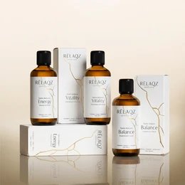 Amber glass bottles, sauna essential oils set, three 100ml bottles, black caps, minimalist white packaging, wellness ritual collection.