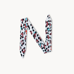 Colorful patterned bracelet with a modern, abstract design featuring various shapes and hues.