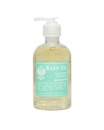 A duo of blood orange-scented hand soap and lotion in a sleek caddy. The soap and lotion feature a vibrant orange color and a refreshing blood orange fragrance.