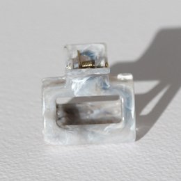  Small gray swirl hair clip, translucent acrylic material, minimalist spiral design, compact size accessory.