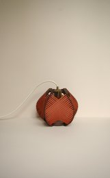 Brick-patterned table lamp with electrical cords for ceiling or tabletop placement.