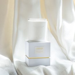 Premium leather scented candle with vanilla and coconut fragrance, in a white and gold box.