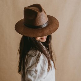 A brown panama-style hat with a wide brim and a leather band.