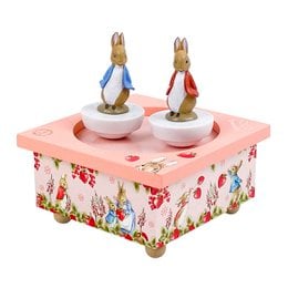 "A whimsical music box featuring two dancing Peter Rabbit figurines on a floral-patterned base. The box plays a soothing melody, perfect for soothing a baby to sleep."