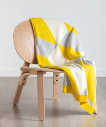 Large yellow and white throw blanket with a soft, cozy texture.