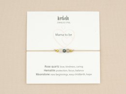 Silver and gold bracelet with charms for expecting mothers, available in silver and gold variants.