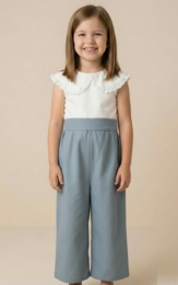  White lace top with gray wide-leg pants, suitable for kids. Floral decor in the background.