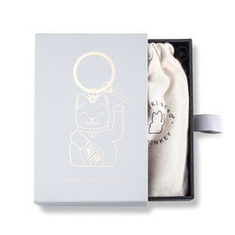 Gray Maneki Neko keyring with gold-tone hardware and a lucky cat charm. Compact and portable design for everyday use.