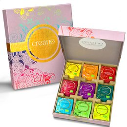 The product is an organic herbal tea gift box containing 45 assorted tea bags. The box features a colorful, floral design with a prominent circular logo. The tea bags likely contain a variety of herbal tea flavors.