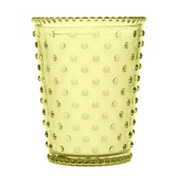 A tall, round glass candle in a chestnut color with a hobnail texture and pattern. The candle has a rustic, vintage-inspired design.