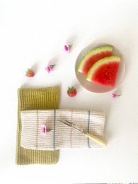 Olive and striped knitted dishcloth, made of cotton material, with a rectangular shape and textured surface.