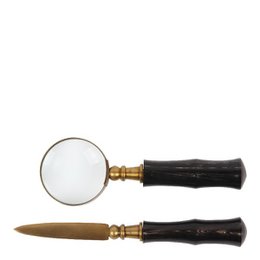  A set of 2 copper-colored wooden clips, one with a magnifying glass and one with a tool for opening items.