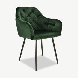  Green velvet dining chair with black metal legs, tufted backrest, and armrests.