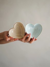 Heart-shaped bath toy in pink, blue, and sand colors.