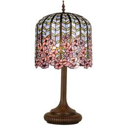 A Tiffany-style table lamp with a dome-shaped shade featuring a colorful floral and leaf pattern in shades of pink, purple, and green. The lamp has a bronze-finished metal base and stands approximately 84 cm tall.