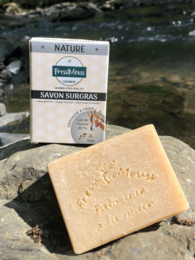 Natural soap bar made with 40% organic goat's milk and honey, featuring a rectangular shape and a light tan color.