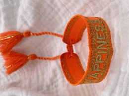 Vibrant orange charm bracelet with 'Happiness' text. Woven bracelet design with adjustable closure.