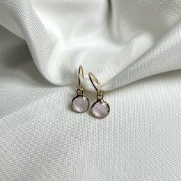  Classy gold-tone hoop earrings with pink gemstones. Elegant and versatile accessory for any occasion.