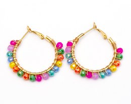  Stainless steel gold-colored statement earrings with an oval design. The earrings feature a textured, hammered finish for a unique, eye-catching look.