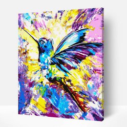 A vibrant, colorful painting of a hummingbird with bold, expressive brushstrokes and a dynamic, abstract style. The painting features a striking blue hummingbird with vibrant splashes of yellow, purple, and other colors creating a lively, energetic composition.