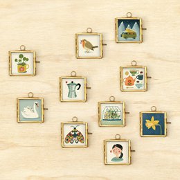  Glass frame with print of Pilea plant in a red pot. Framed artwork features green leaves and stems of the Pilea plant.