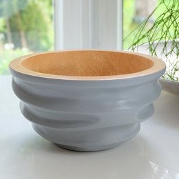 A round, gray ceramic bowl with a wooden interior, available in multiple sizes, suitable for serving fruit, salad, or other foods.