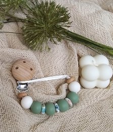 Boho-style newborn pacifier clip with beads in earthy tones and natural materials.