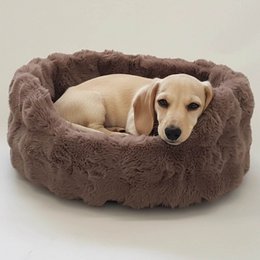  Cream-colored, plush dog basket with a small dog resting inside.