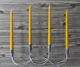 Handmade 10" beeswax taper candles in a set of 4, with a yellow color and cylindrical shape.