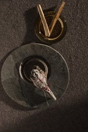 Palo Santo reed diffuser with natural wooden sticks and glass container.