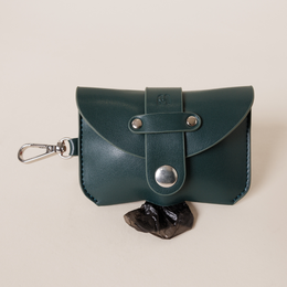  Dark green leather poop bag holder with snap closure and carabiner clip for dog walks.
