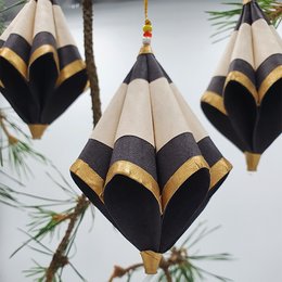 Set of 3 black and gold folded paper ornaments with a natural finish.