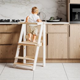  A collapsible learning tower made of natural wood with a transparent white, purple, sky blue, and coating-free variants. The tower features a sturdy step design and is suitable for use as a footstool.