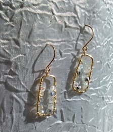 Gold-toned drop earrings with clear stones, featuring a modern, geometric design.